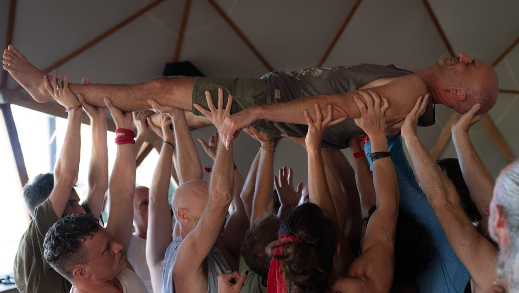 A man held above the heads of a group of men
